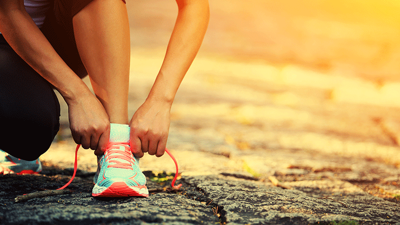 Woman tying shoes